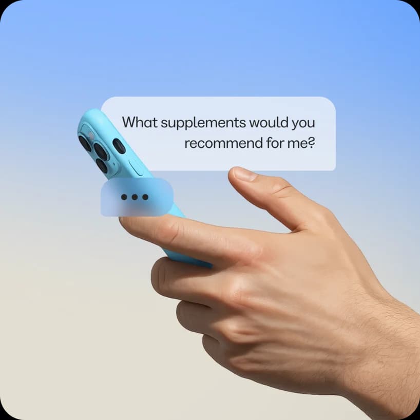 Hand holding a phone with a chat bubble asking about supplements